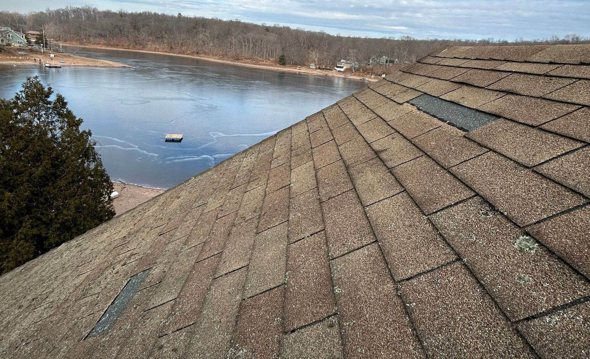Aerial view of a roofing team performing emergency storm damage repairs in Avon, Hartford County
