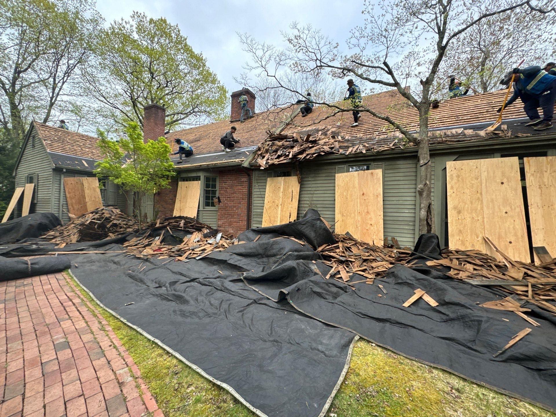 Roof Demolition with Tarps and plywood to protect the property and landscape in West Hartford, CT