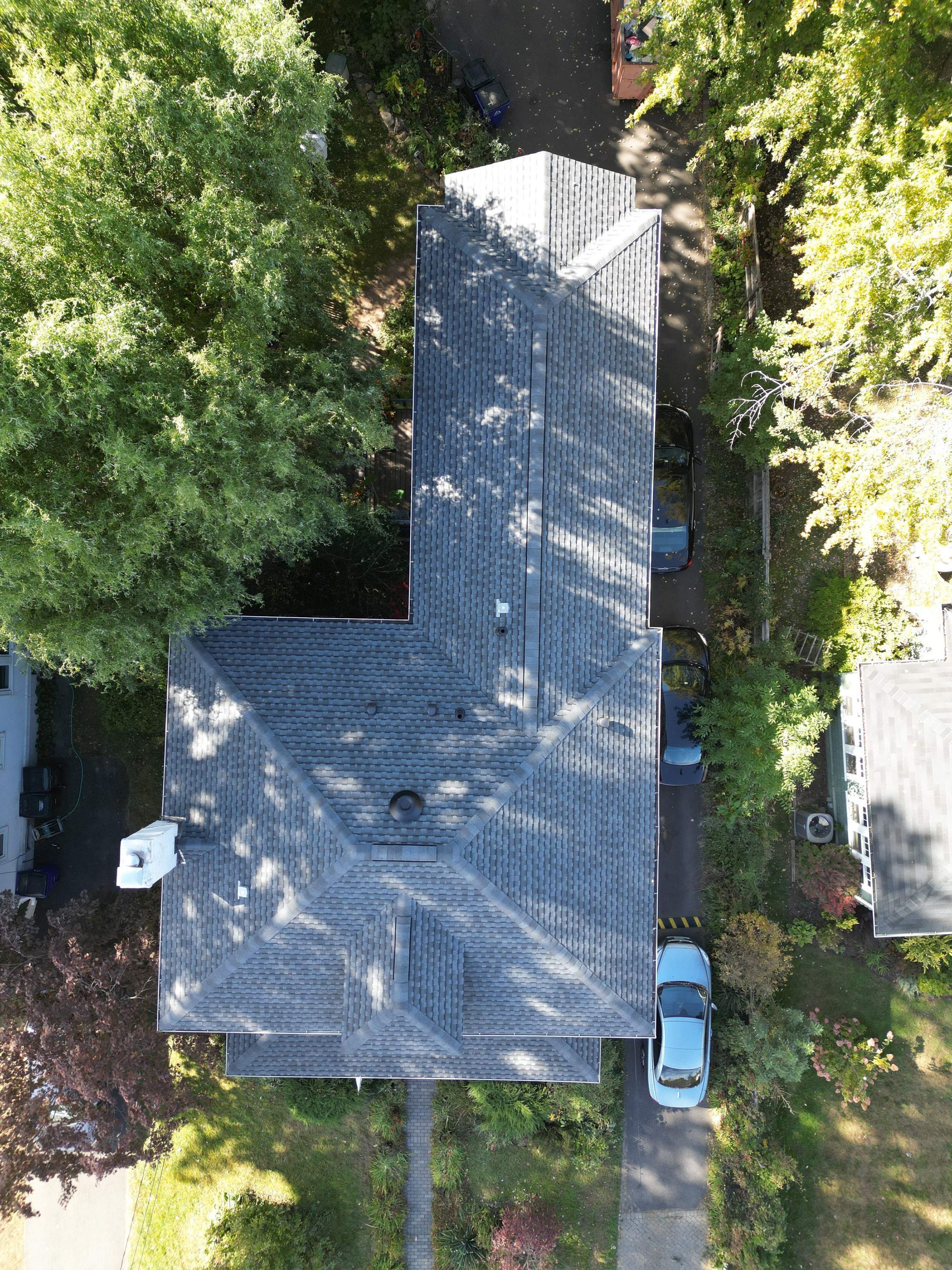 An aerial view of a house with a newly installed roof in Connecticut