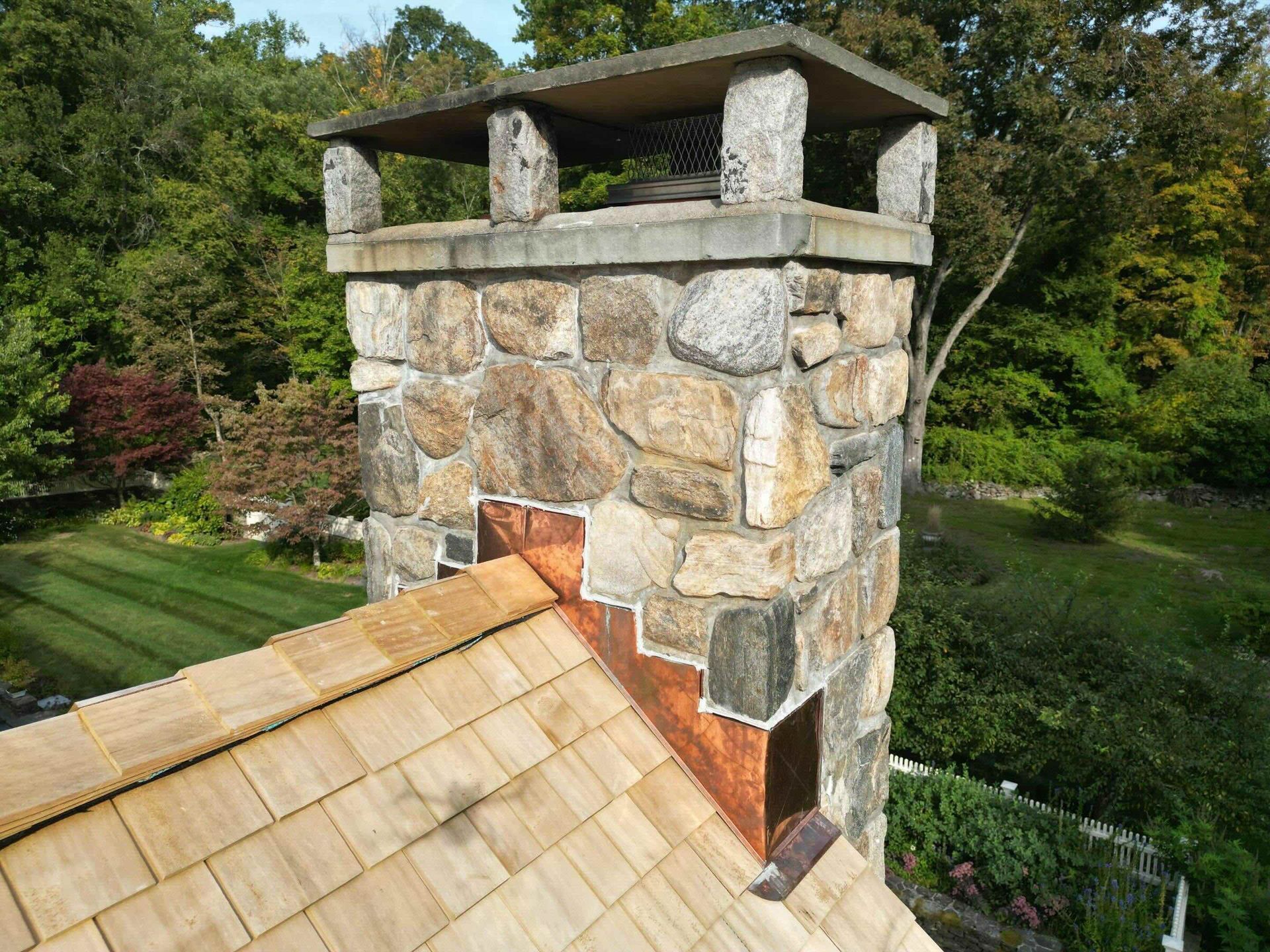 Copper Chimney Flashing installed on Stone Veneer and Cedar Roof in Connecticut