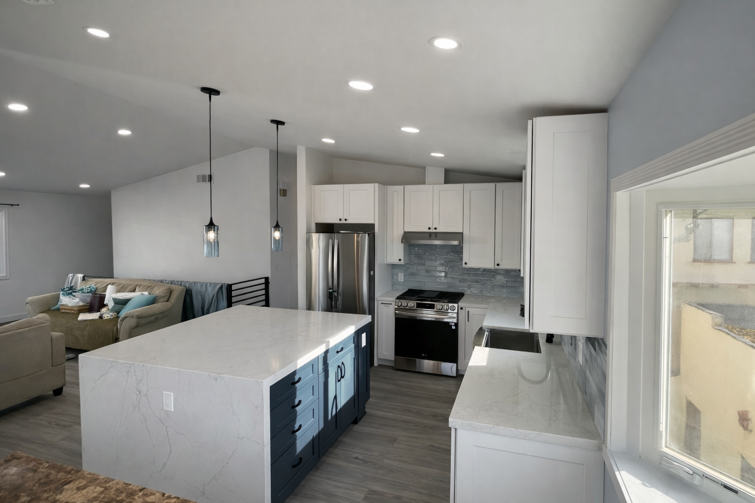 Living room with white walls, built-in shelving, TV, and cream curtains.