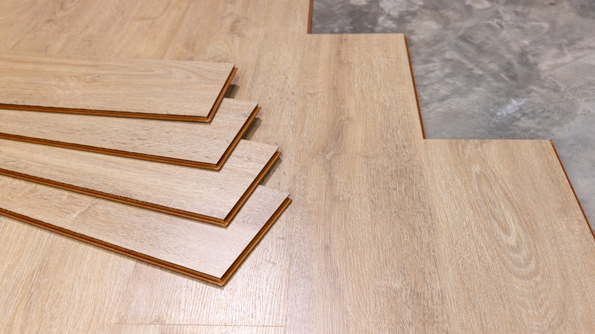 Spacious living room with white sofa, wood furniture, and large windows overlooking a patio.