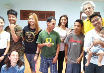 A group of people posing for a picture with one man wearing a shirt that says o on it