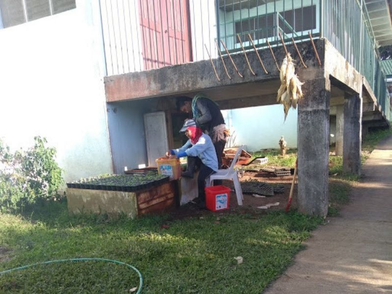 A man is sitting on a chair under a building