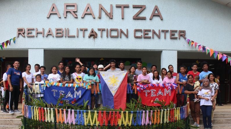 A group of people standing in front of the arantza rehabilitation center