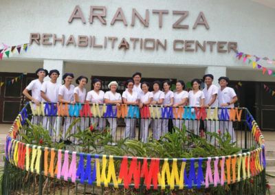 A group of people standing in front of the arantza rehabilitation center