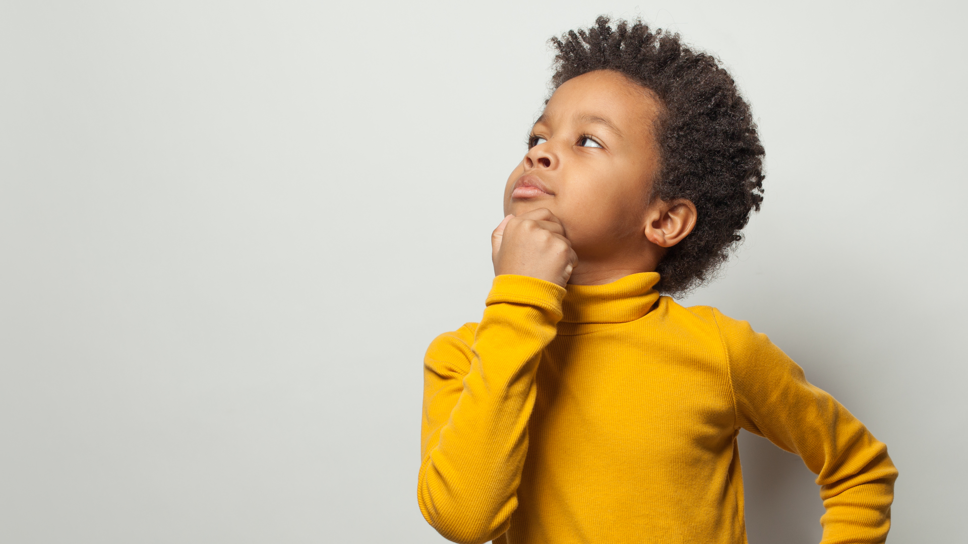 A baby is crawling through a tunnel in a classroom.