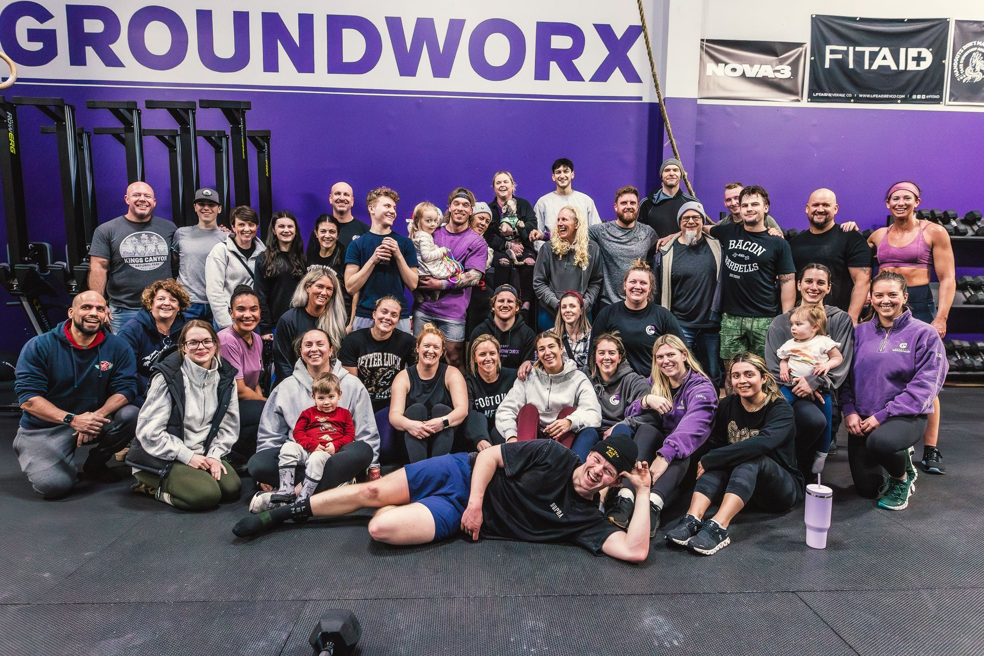 A group of people are posing for a picture in a gym.