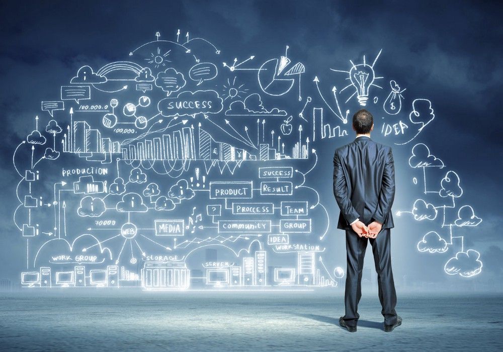 A man in a suit is looking at a drawing on a wall.