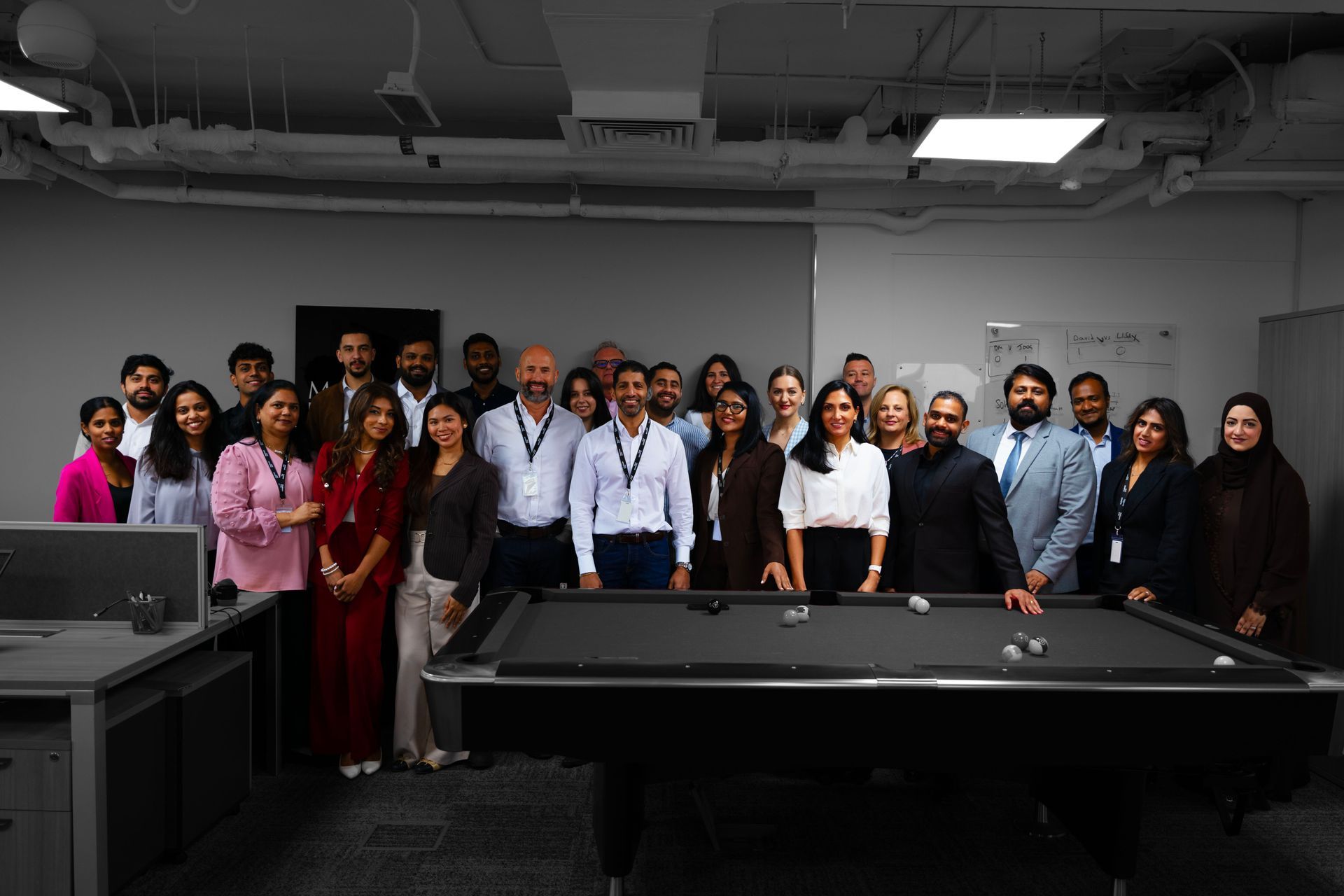 A man and a woman are sitting at a table with a laptop.