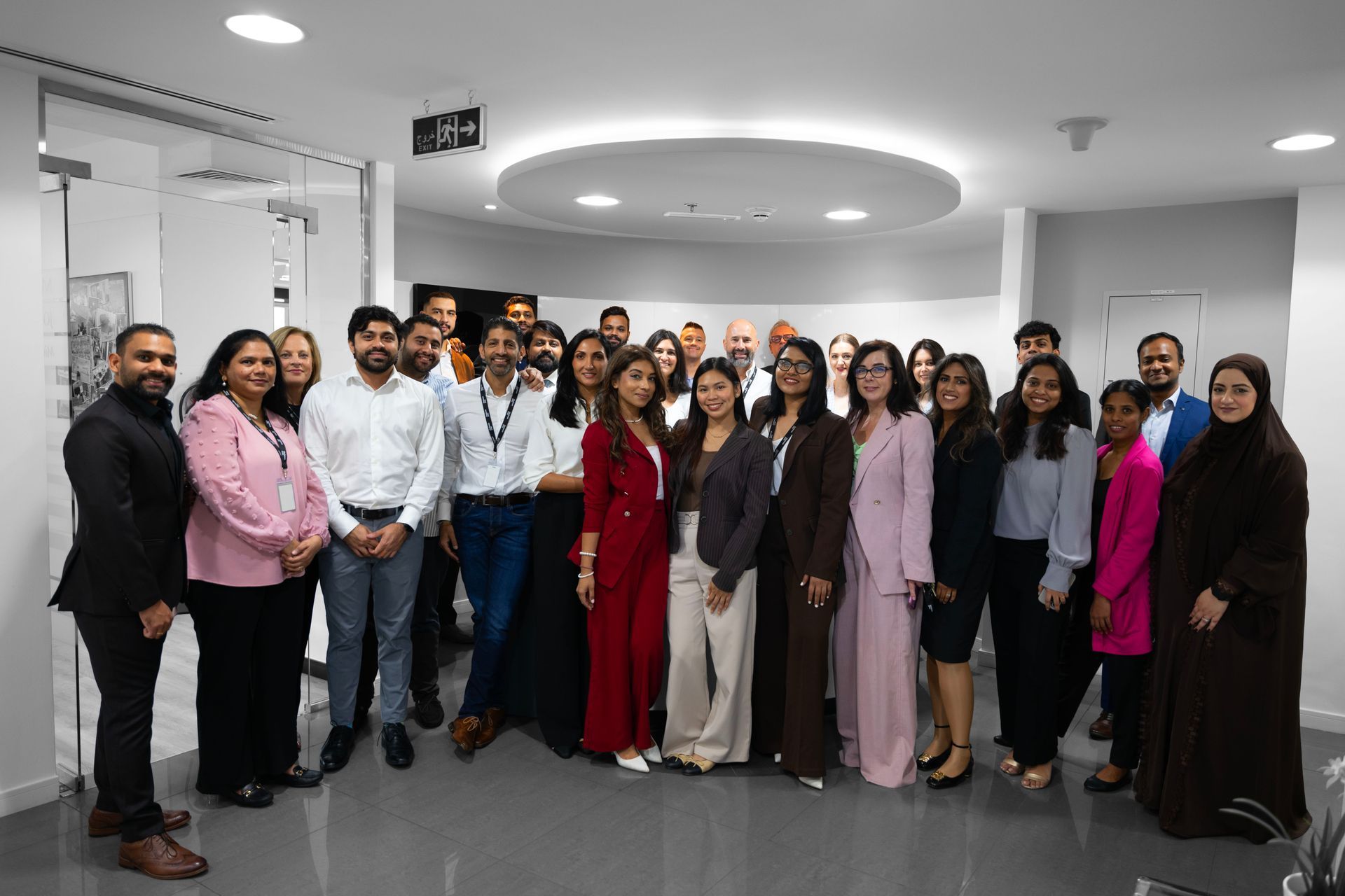 A man and a woman are sitting at a table with a laptop.