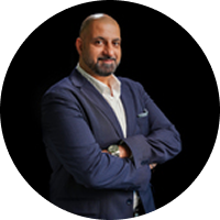 A man in a suit is standing in a circle with his arms crossed.