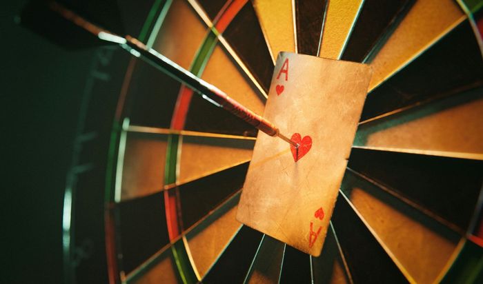 A dart board with an ace of hearts in the center