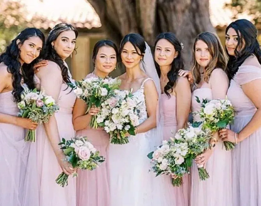 bride a bridesmaid in pale pastel colors with hair and makeup by Moderne Beauty in San Jose, Cali