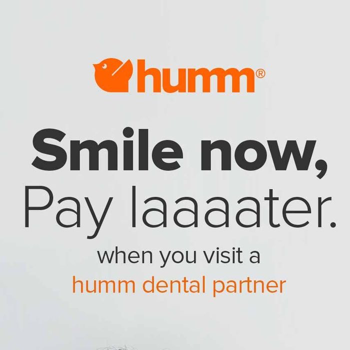 A poster that says smile now pay laaater when you visit a humm dental partner