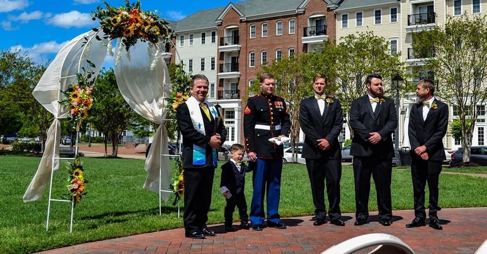 A group of men standing next to each other in a park.