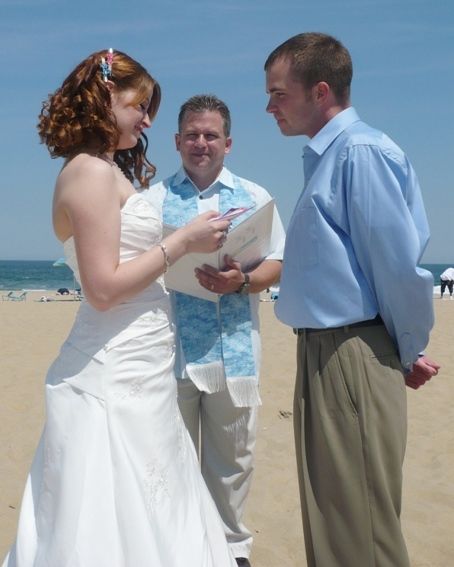 A bride and groom are getting married on the beach