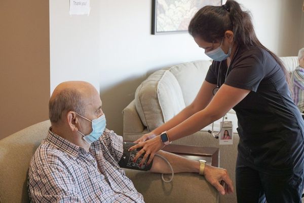 retirement living hamilton residences. Nurse caring for resident