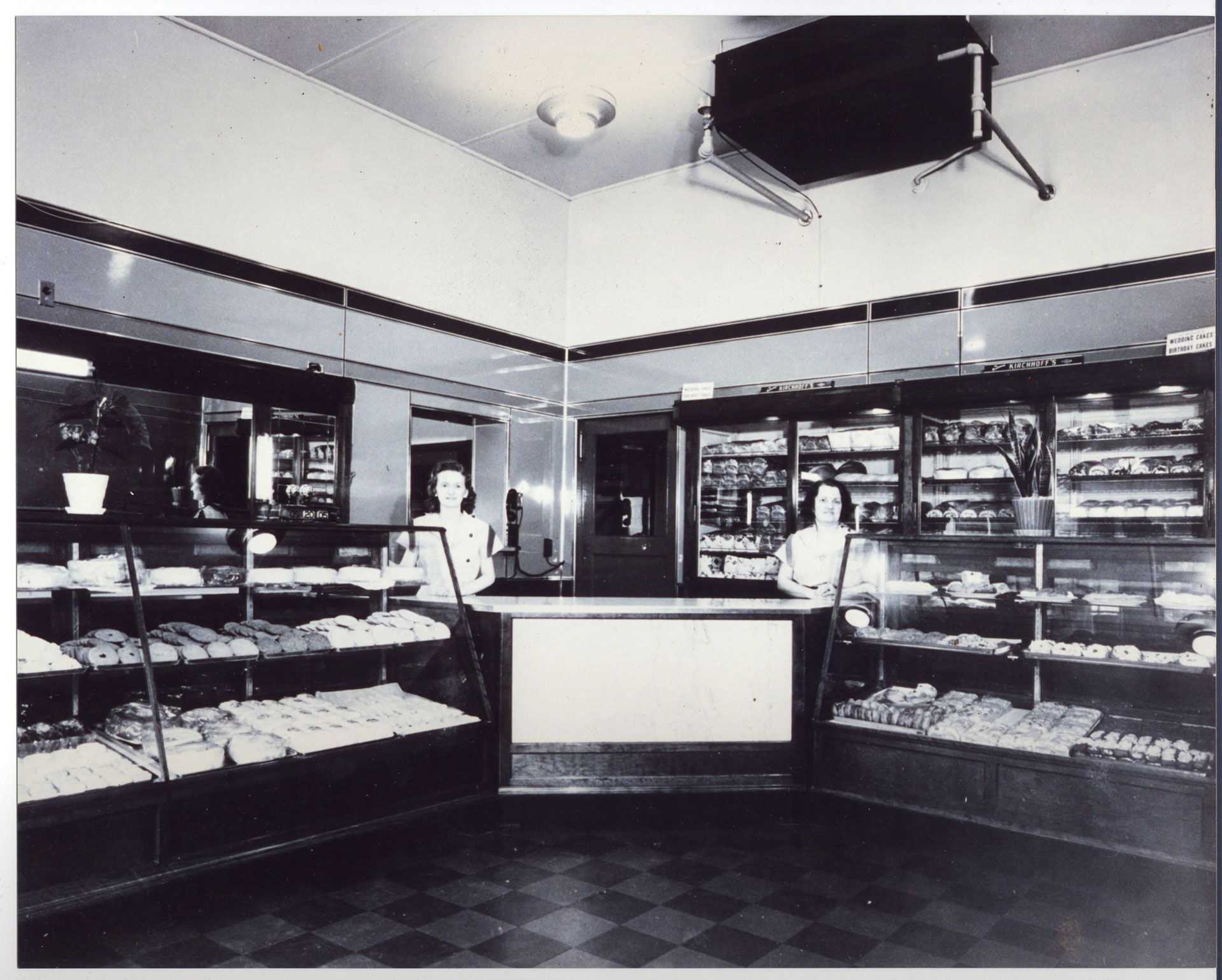 A black and white photo of the inside of a bakery