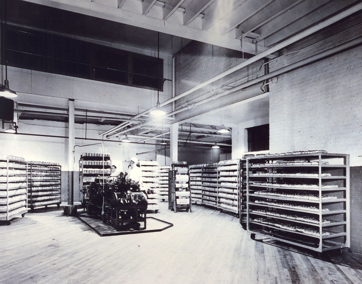 A black and white photo of a warehouse with lots of shelves