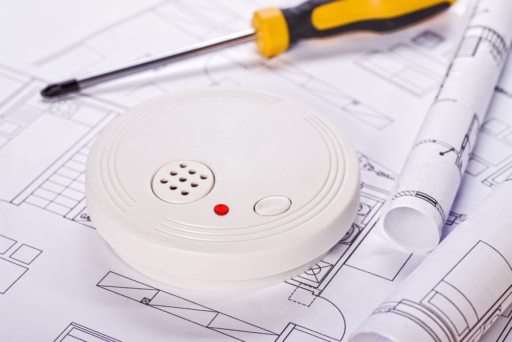 Smoke Detector With Screwdriver and Blueprints — Grant Murphy Electrical in Pottsville, NSW
