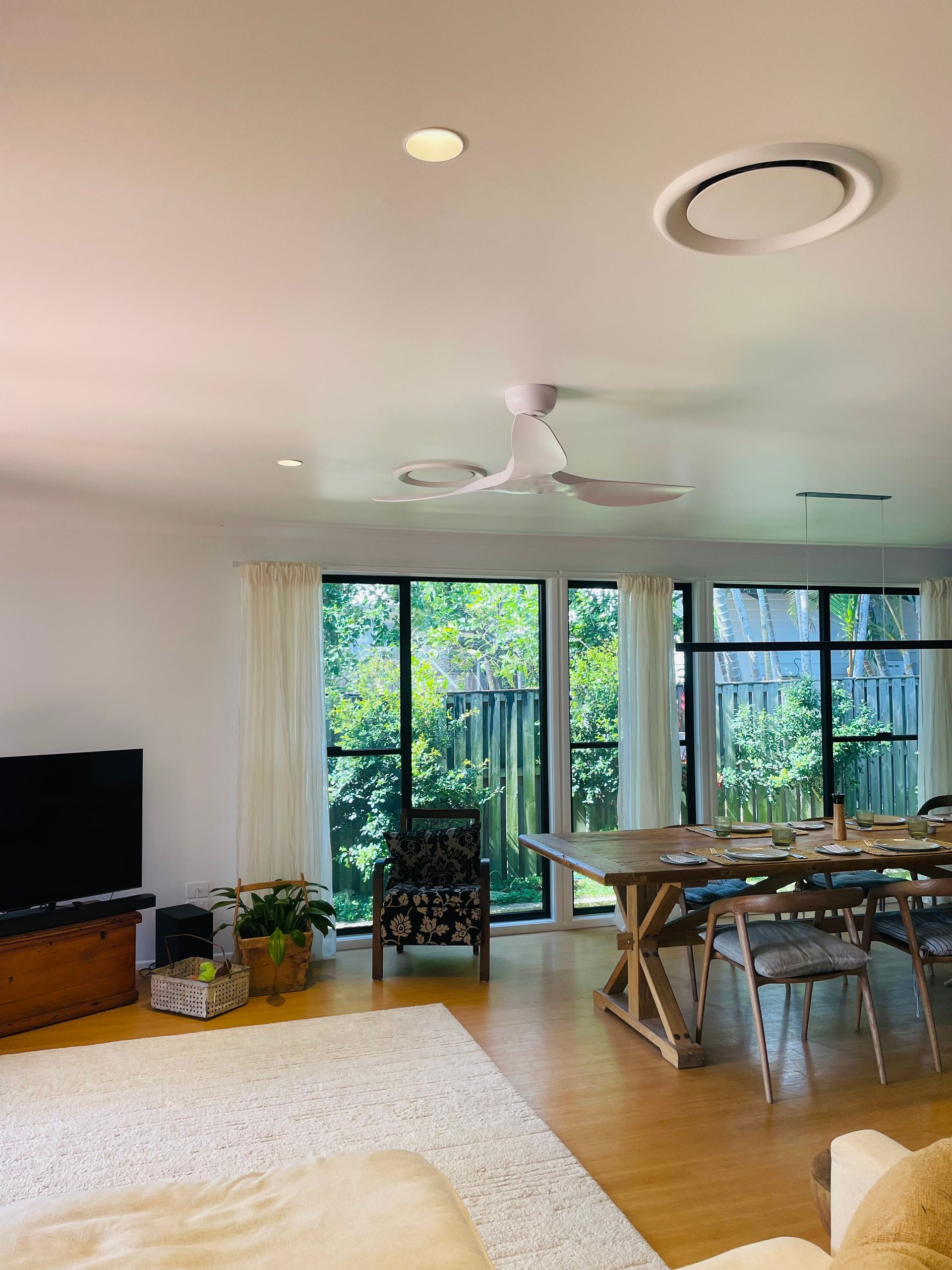 Bright, Airy Living Room With a Dining Table, Ceiling Fan — Grant Murphy Electrical in Kingscliff, NSW
