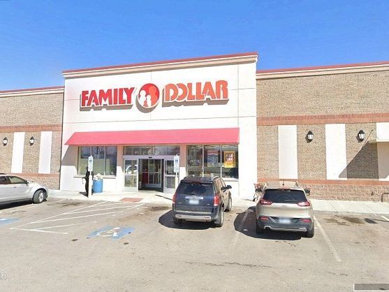 A large building with a handicapped parking spot in front of it.