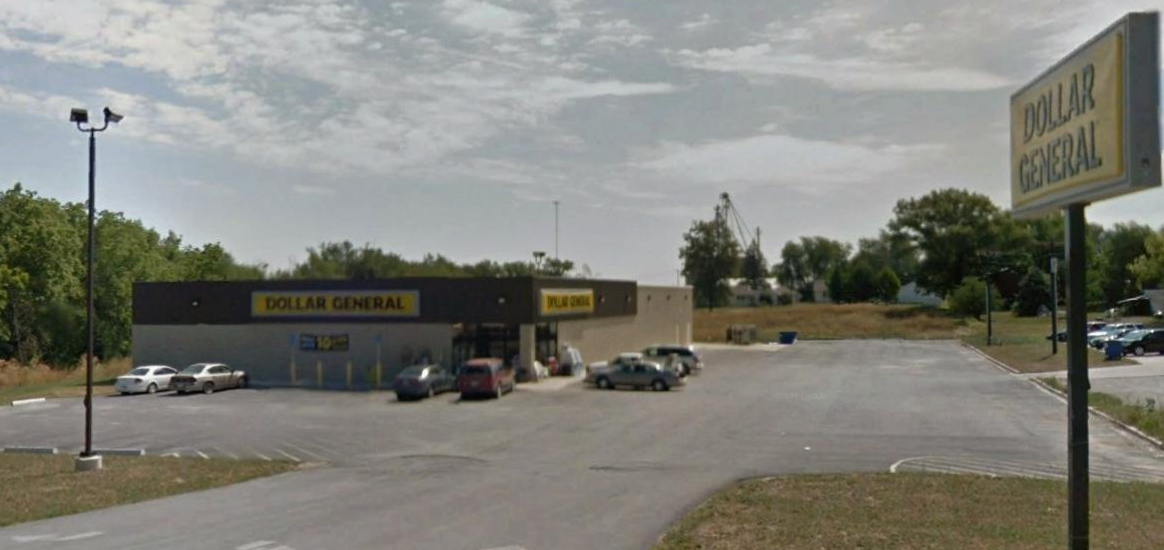 A parking lot with cars parked in front of a store.