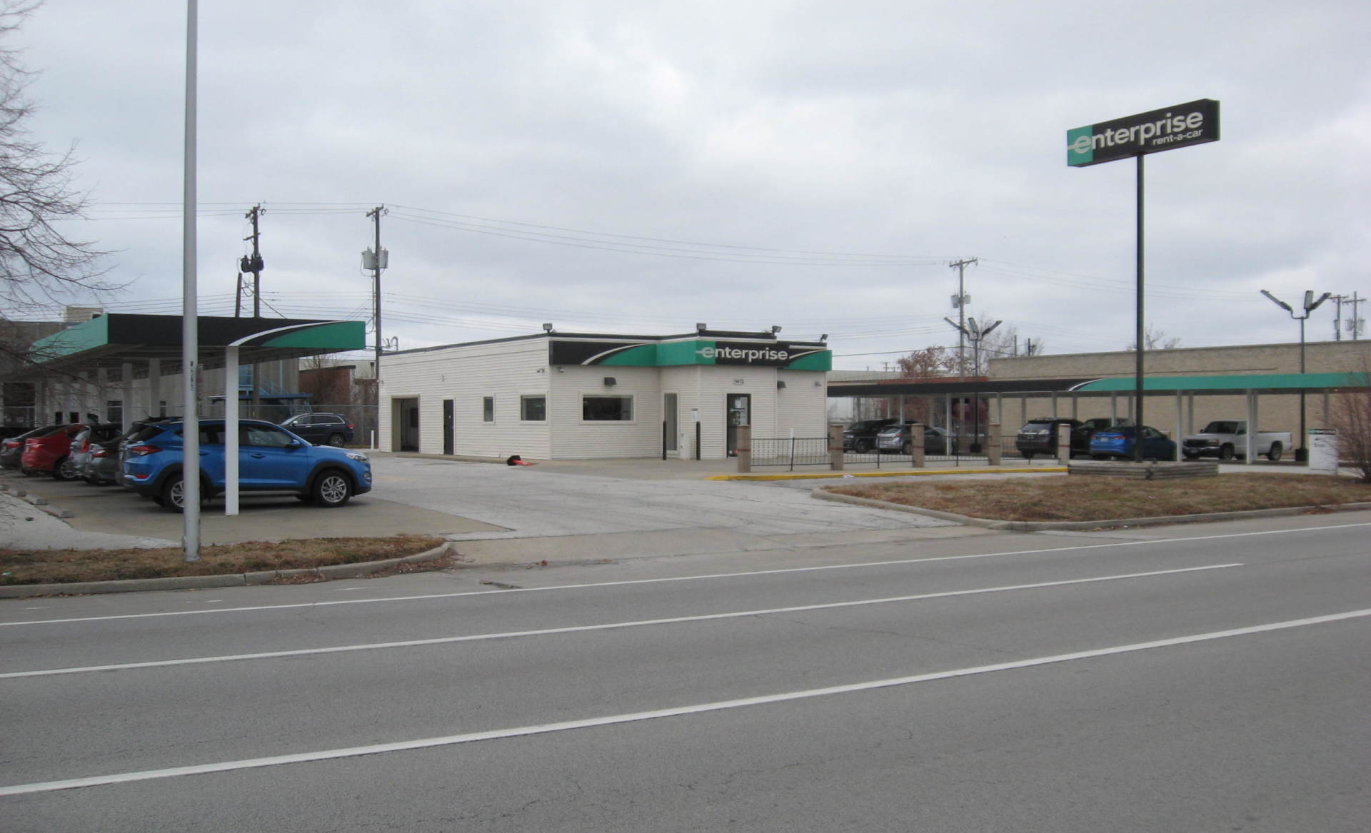 A blue truck is parked in front of a car wash