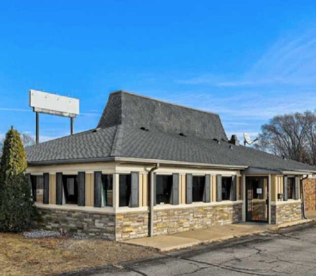 A parking lot with a red awning over it