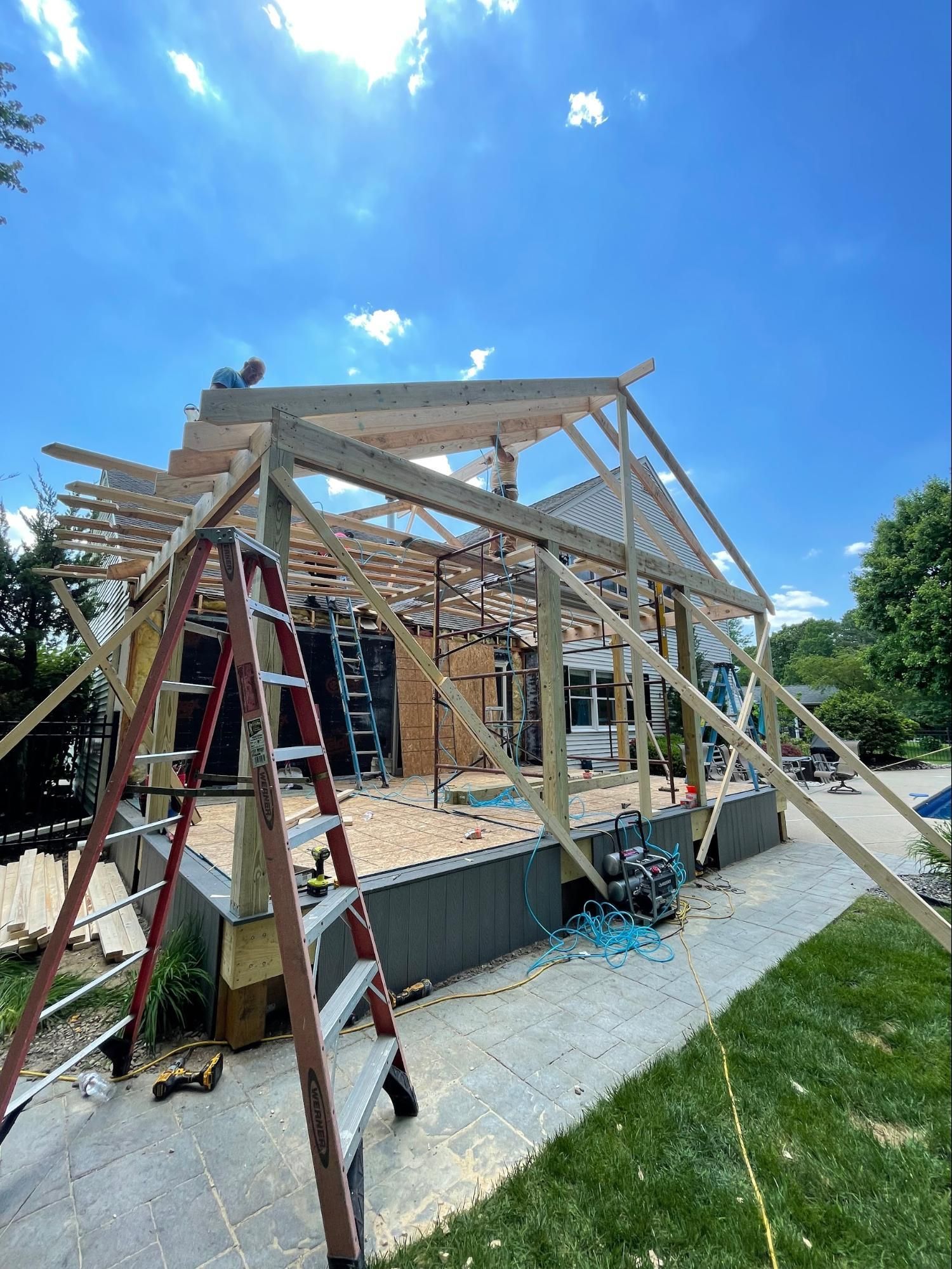 a crane is being used to remove the roof of a house