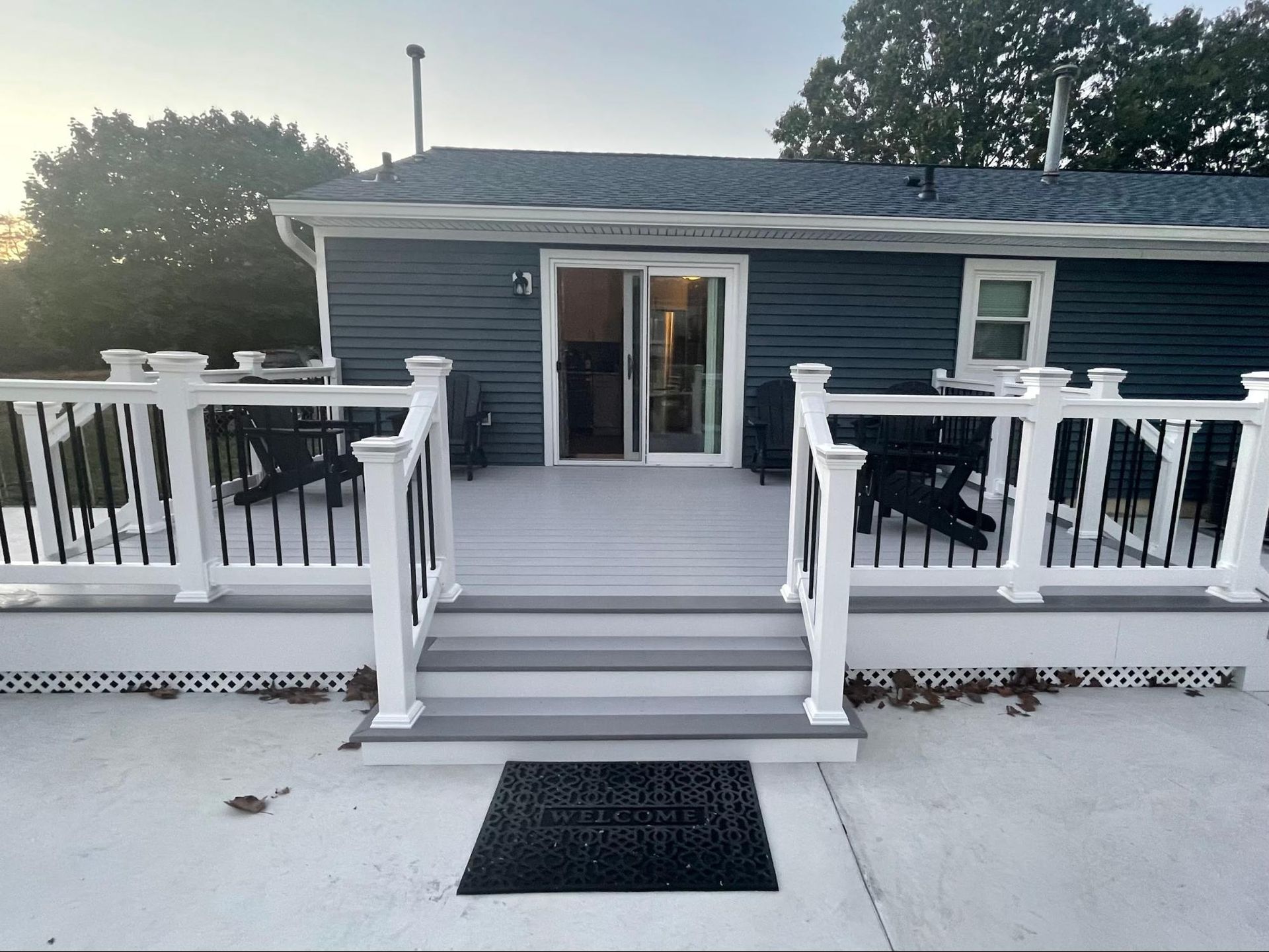 a blue house with a white deck in front of it
