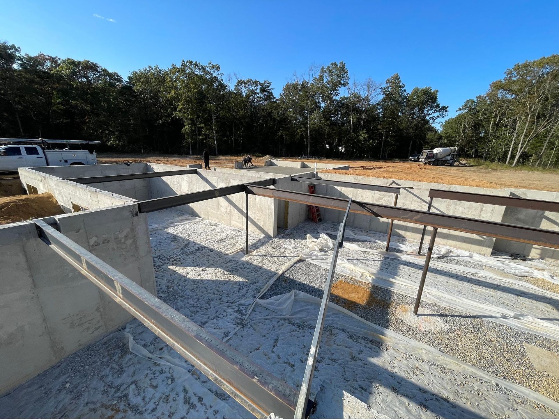 a construction site with a blue sky and trees in the background