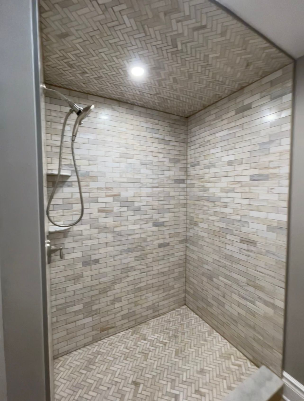 a bathroom with a walk in shower and a shower head
