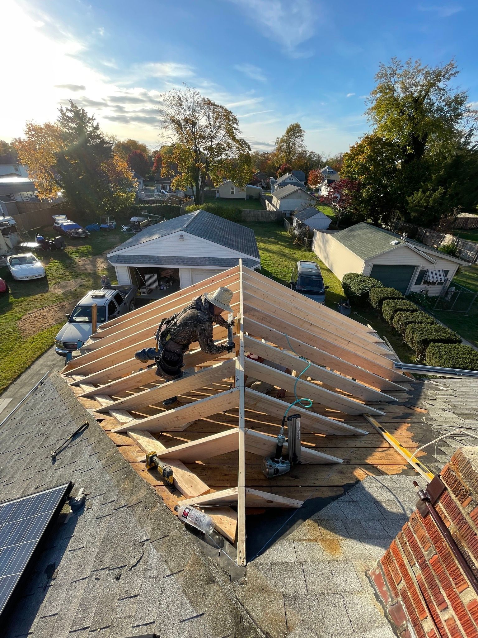 a man is working on the roof of a house