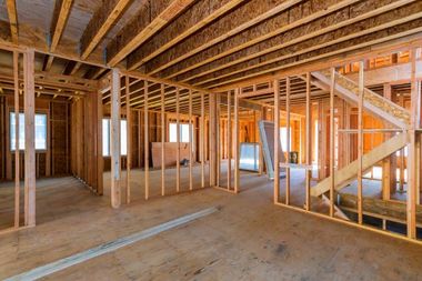 the inside of a house under construction with wooden beams and stairs