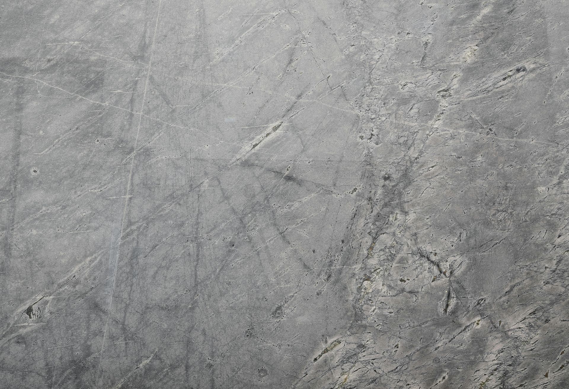 A close up of a gray concrete surface with a marble texture.