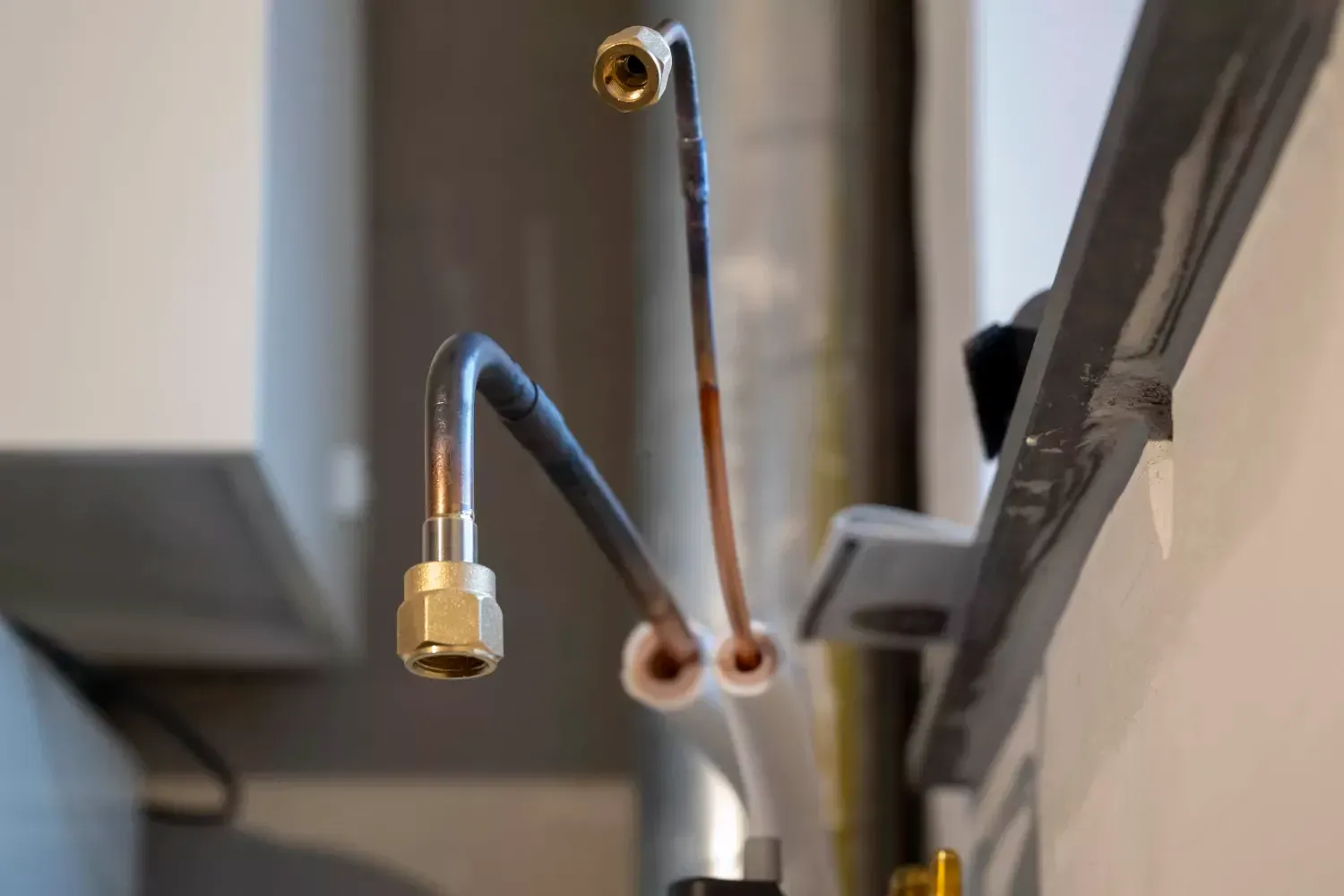 A person is fixing a faucet with a wrench.