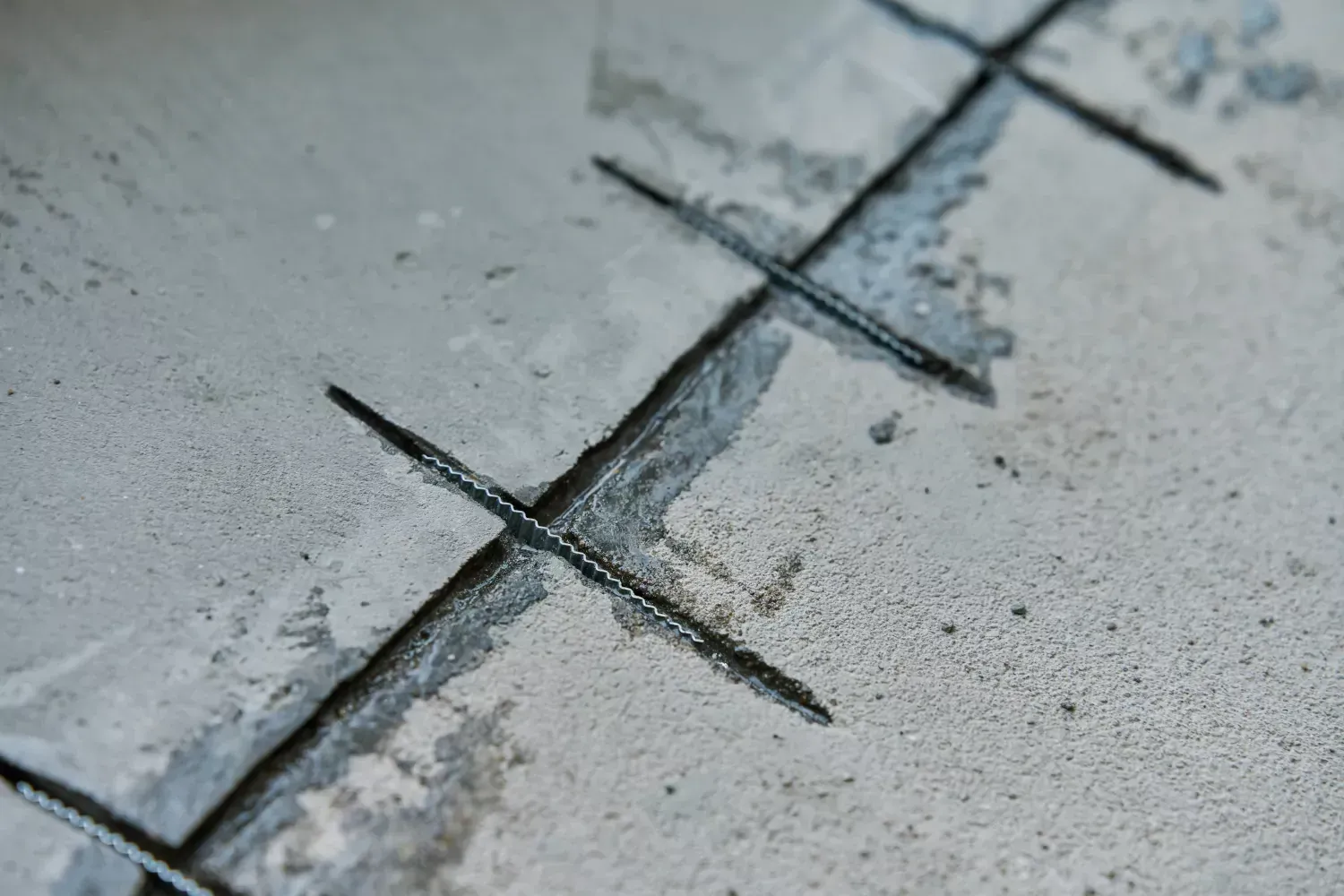 A close up of a concrete floor with cracks in it.