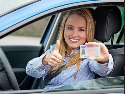 Driving Courses — Young Girl In The Car With Card In Hand in Mine Hill, NJ