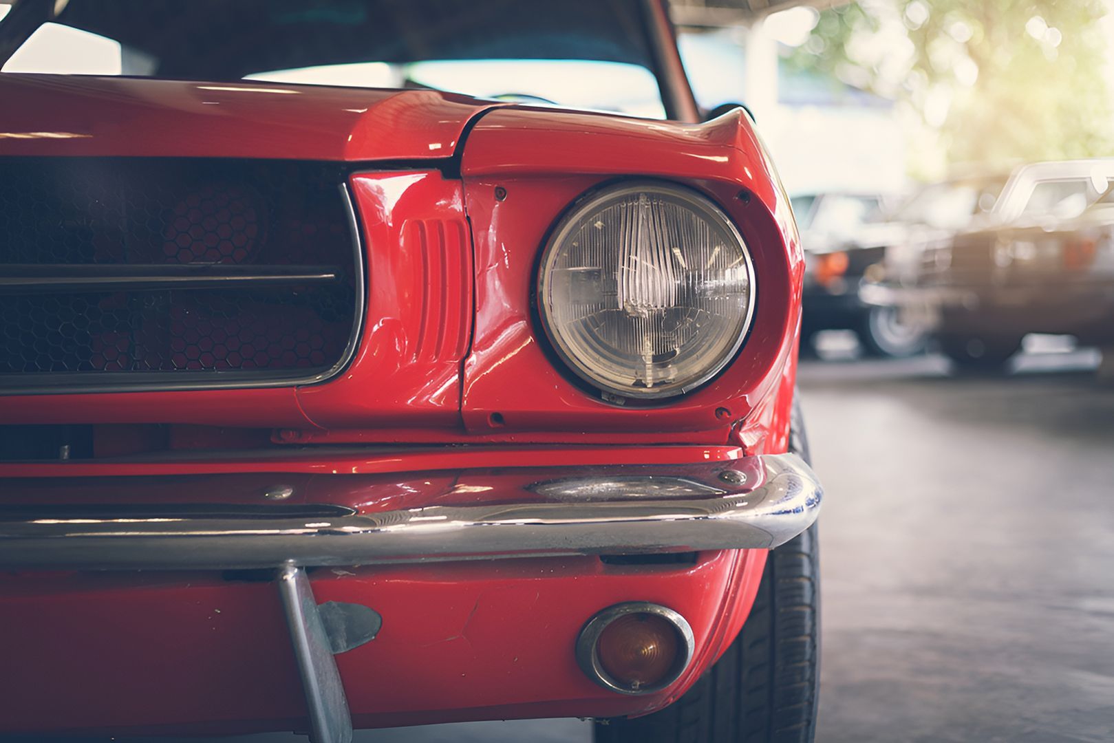 close up of red classic car front end