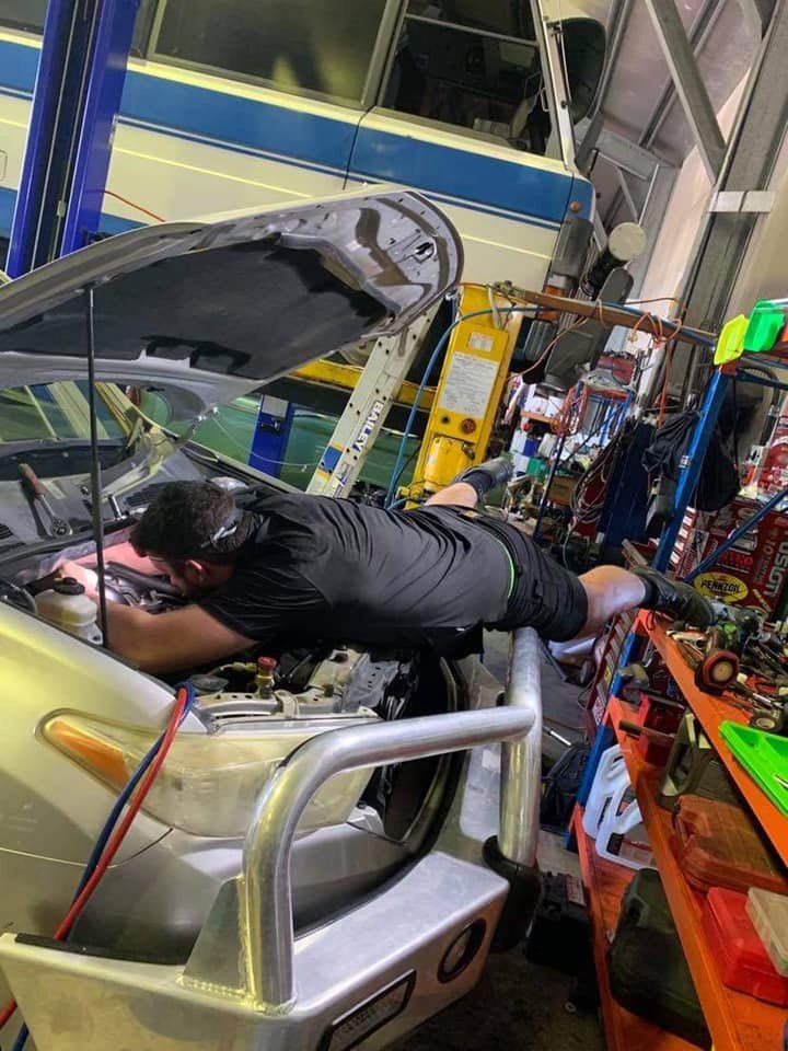 Mechanic Fixing The Car Engine — Cairns Auto Electrical Mechanical Air & Audio in Stratford, QLD