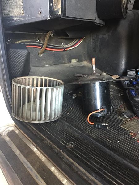 A Blower Wheel is Sitting Next to a Motor in a Car — Cairns Auto Electrical Mechanical Air & Audio in Stratford, QLD
