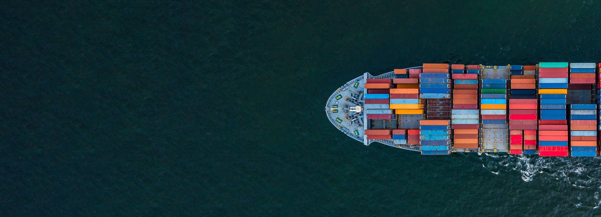 An aerial view of a large container ship floating on top of a body of water.