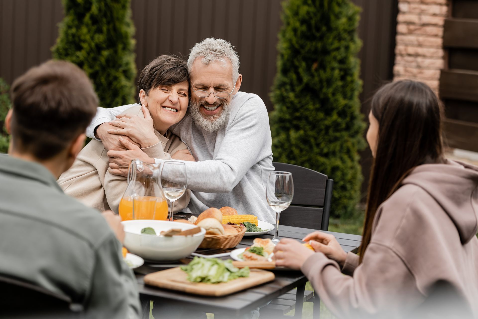 A group of people are sitting at a table eating food.