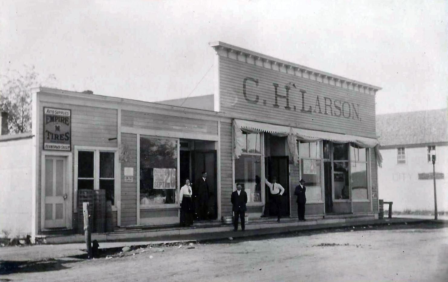 A black and white photo of a c.h. larson store