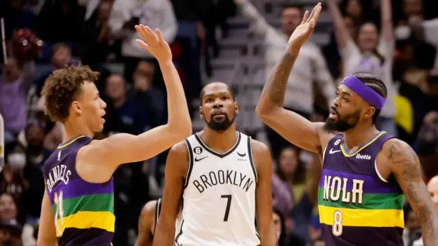 A group of basketball players are standing next to each other on a court.