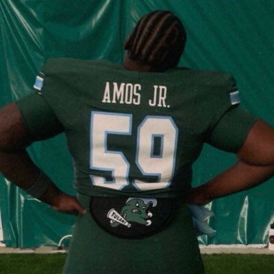 Back view of a football player in green jersey number 59 with “AMOS JR.” on the back.