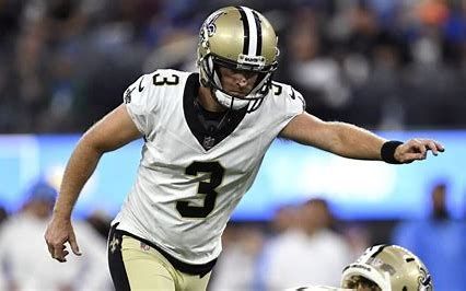 A football player is kicking a field goal during a game.