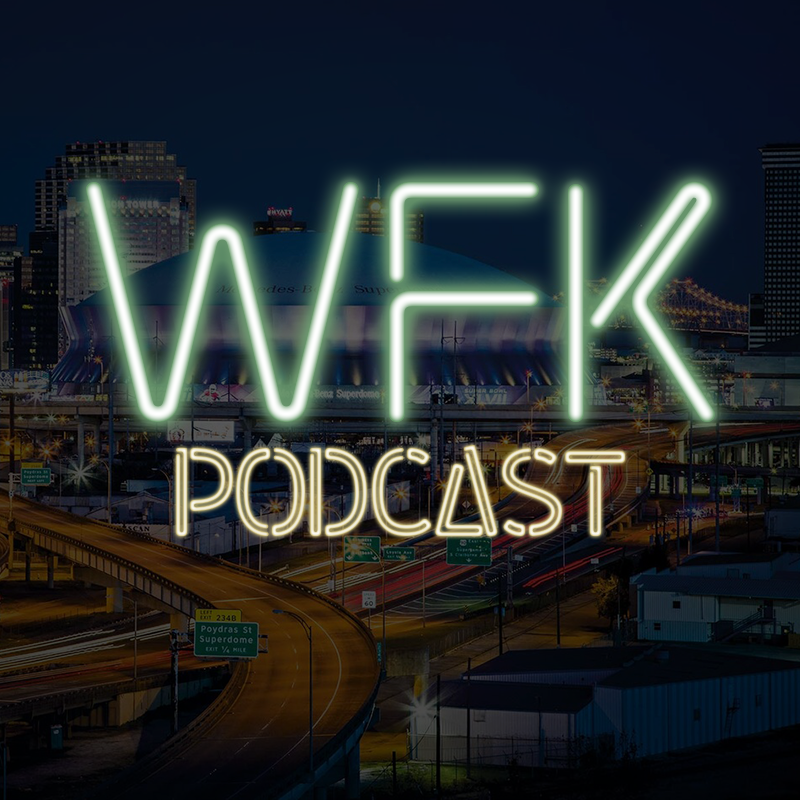 A neon sign for a podcast with a city in the background.